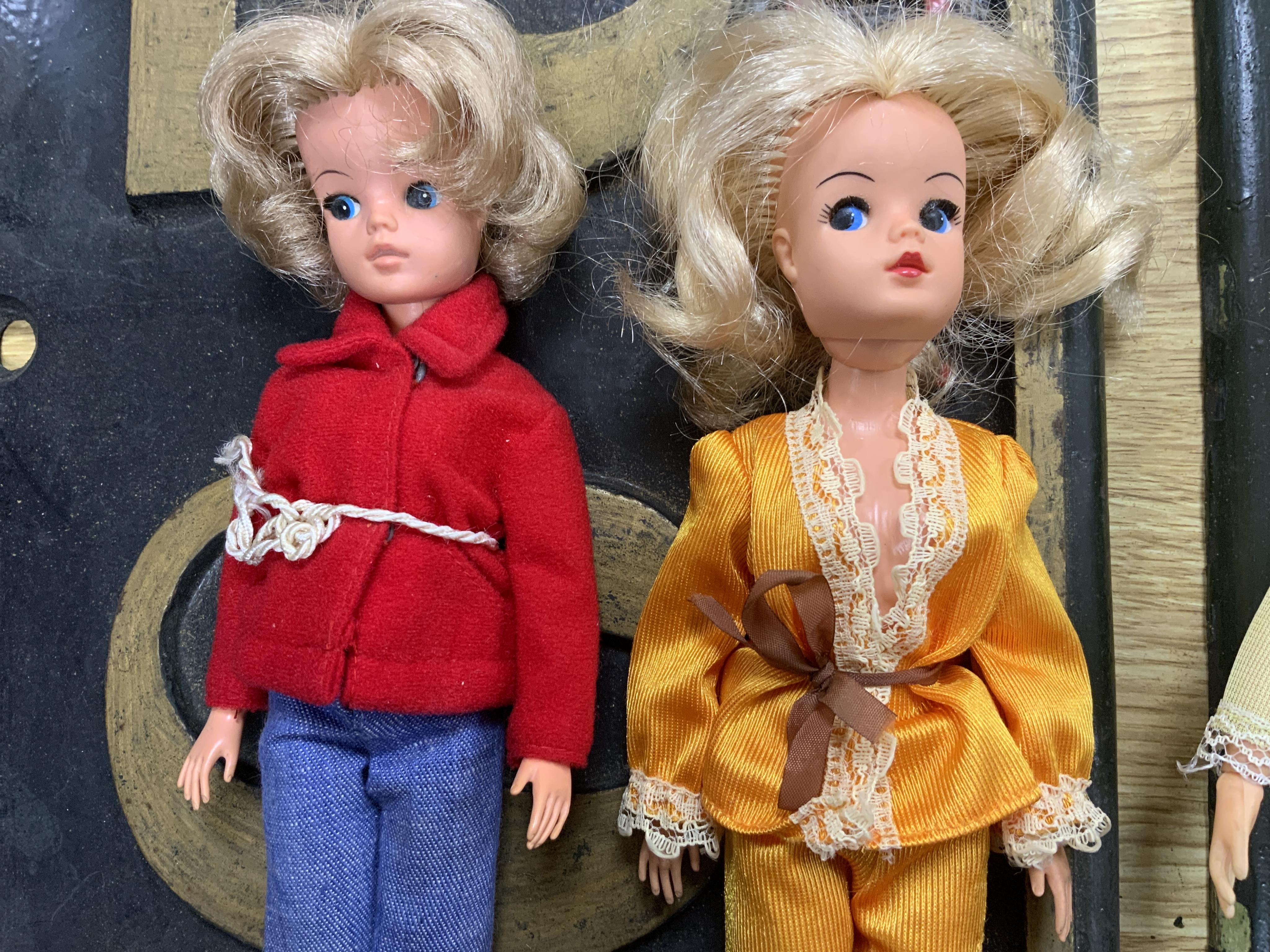 A collection of 1960s-80s Sindy dolls and accessories, including; five dolls, an early plywood and hardboard caravan, a large selection of clothing and accessories, furniture, house fittings, including a shower, wardrobe